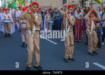 Haifa, Israel - April 27, 2019: Scouts perform a Holy Saturday parade, carrying the holy fire, and crowd attend and document, part of Orthodox Easter  Stock Photo