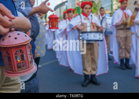 Haifa, Israel - April 27, 2019: Holy fire being held, and scouts perform a Holy Saturday parade, part of Orthodox Easter celebration in Haifa, Israel Stock Photo