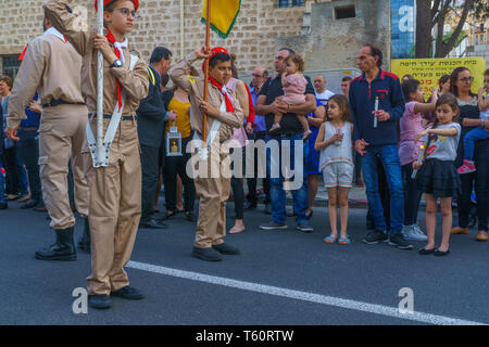 Haifa, Israel - April 27, 2019: Scouts perform a Holy Saturday parade, and crowd attend and hold the holy fire, part of Orthodox Easter celebration in Stock Photo