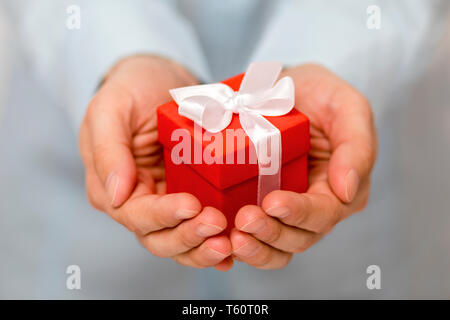 Small red present box in hands Stock Photo