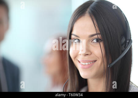 Portrait of a smiling creative businesswoman with earpiece in office Stock Photo