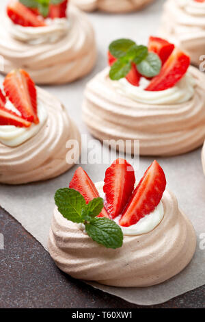 pavlova chocolate mini cakes with strawberries close-up Stock Photo