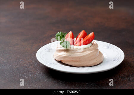 pavlova chocolate mini cakes with strawberries close-up Stock Photo