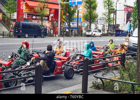 Many young people cosplay as various pop culture characters while driving rental go-karts around Akihabara, Tokyo, Japan. Stock Photo