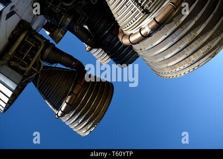 Apollo Saturn V booster rocket with large powerful liquid oxygen fueled rocket engines with a blue sky background Stock Photo