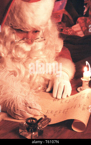 Santa Claus working on Naughty or Nice Gift List, USA Stock Photo