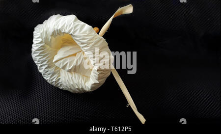 Artificial flowers for funerals on the black background.Funeral traditions in Thailand. Stock Photo