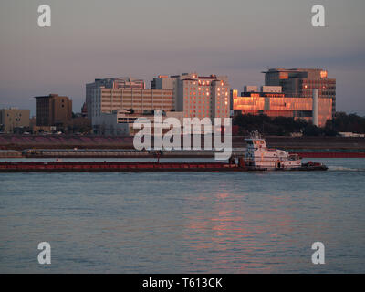 Port Allen, Louisiana, USA - 2019: Downtown Baton Rouge is seen from across the Mississippi River as a towboat travels upstream. Stock Photo