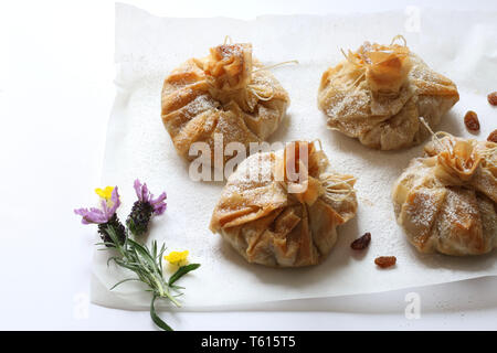 Phyllo pastry strudel with apple filling and sultana grapes, dusted with icing sugar Stock Photo