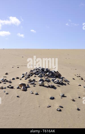 Pile of stones in a desert in Maspalomas, Spain Stock Photo