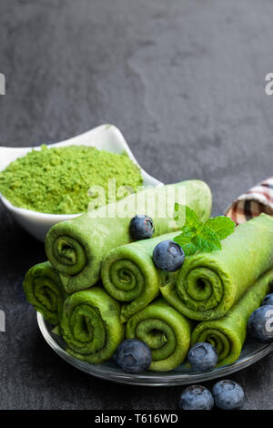Matcha  green tea crepe with whipped cream and blueberry isolated on white Stock Photo