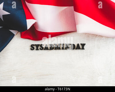 Beautiful greeting card for Sysadmin Day. Wooden letters with a congratulatory inscription on a white background. Close-up, top view. Congratulations  Stock Photo