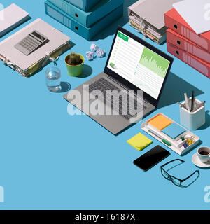 Financial report on a laptop screen, paperwork and office supplies on a desktop: business management and technology concept, blank copy space Stock Photo