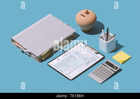 Filing the 1040 individual income tax return form on the office desk, finance and accounting concept, isometric objects Stock Photo