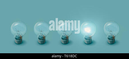 One lit bulb next to unlit bulbs: creativity, ideas and inspiration concept Stock Photo