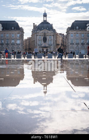BORDEAUX, FRANCE - APRIL 14, 2019: The Place de la Bourse and the water mirror of the Bordeaux quays on a sunny spring day Stock Photo