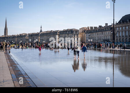 BORDEAUX, FRANCE - APRIL 14, 2019: The water mirror of the Bordeaux quays on a sunny spring day Stock Photo