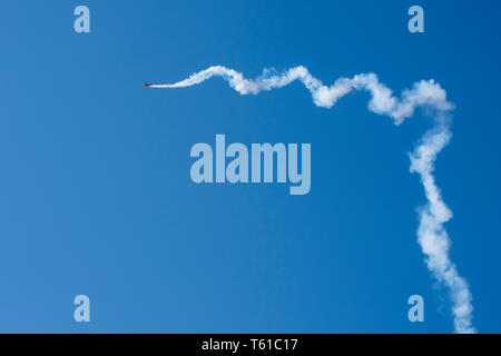 Airplane trails on blue sky with copy space. Stock Photo