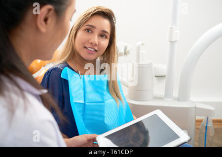 Pretty young woman visiting dentist Stock Photo