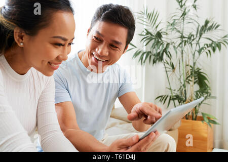 Joyful couple with digital tablet Stock Photo
