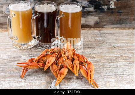 Beer and a boiled crayfishes on a wooden background Stock Photo