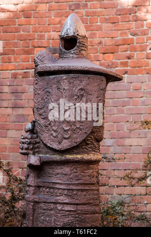 Metal idol in the old city wall. Warsaw. Poland Stock Photo