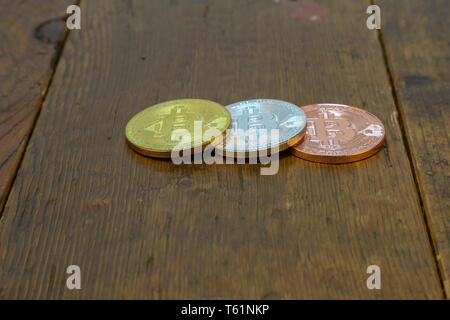 Cryptocurrency. Bitcoins are on the wooden table. Stock Photo