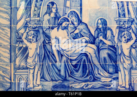 Blue and white traditional Azulejo ceramic tiles forming picture of the dead body of Jesus Christ being cared for by the three Marys, Evora, Alto Alen Stock Photo