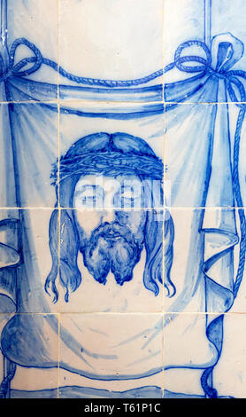 Blue and white traditional Azulejo ceramic tiles forming picture of the head of Jesus Christ wearing a crown of thorns, Evora, Alto Alentejo, Portugal Stock Photo