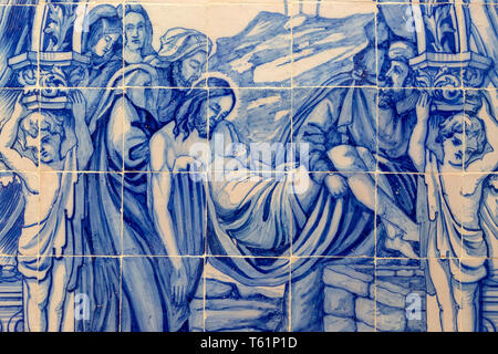 Blue and white traditional Azulejo ceramic tiles forming picture of the death of Jesus Christ being carried away, Evora, Alto Alentejo, Portugal, sout Stock Photo