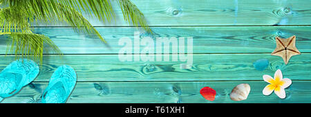 Palm leaf, flip flops and seashells on blue wooden planks, panoramic beach and summer background with copy space Stock Photo