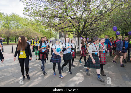 Glasgow, Scotland, UK. 28th April, 2019. Walkers at the start of Kiltwalk Glasgow 2019 in Glasgow Green, a charity event where walkers have three distances to choose from, a Mighty Stride (23 miles), a Big Stroll (14 miles) or the Wee Wander (6 miles). This year 13,000 walkers took part and raised £3.5 million for charity. Credit: Skully/Alamy Live News Stock Photo