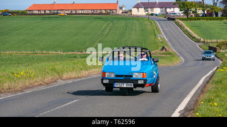 East Lothian, UK. 28 April 2019. Classic Car Tour: North Berwick Rotary Club holds its 3rd rally with 65 classic cars entered. The car rally route is from East Lothian and back through the Scottish Borders, raising money for local charities. A vintage 1993 Reliant Robin three wheeled car driving on a country road Stock Photo