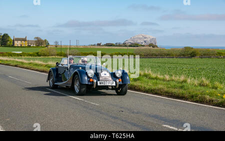 East Lothian, UK. 28 April 2019. Classic Car Tour: North Berwick Rotary Club holds its 3rd rally with 65 classic cars entered. A 2007 Morgan sports car with Bass Rock in the background Stock Photo