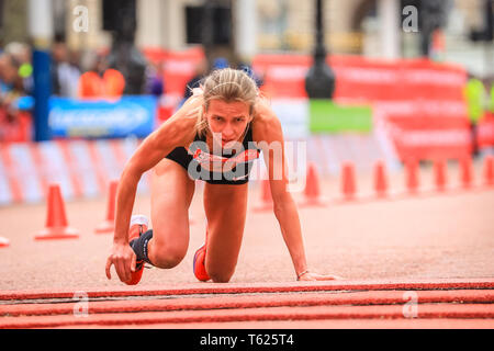 London, UK. 28th April 2019. Hayley  Carruthers (GBR) finishes the race in 2.33.59, but collapses just before the finish and crawls over the finish line. The Mall with the finish line, Elite Men's and Women's races. The world's top runners once again assemble in for the London marathon, to contest the 39th race. Credit: Imageplotter/Alamy Live News Stock Photo