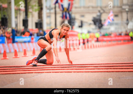 London, UK. 28th April 2019. Hayley  Carruthers (GBR) finishes the race in 2.33.59, but collapses just before the finish and crawls over the finish line. The Mall with the finish line, Elite Men's and Women's races. The world's top runners once again assemble in for the London marathon, to contest the 39th race. Credit: Imageplotter/Alamy Live News Stock Photo