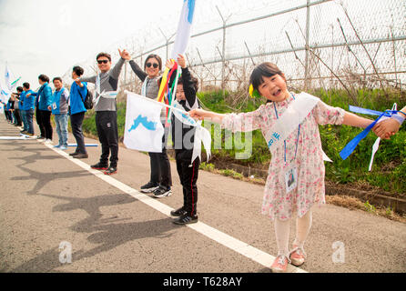 Paju, South Korea. 27th Apr, 2019. Human chain near DMZ, Apr 27, 2019 : People are lined up to create a 'human chain' near the demilitarized zone (DMZ) separating the two Koreas in Paju, north of Seoul, South Korea during a rally held to celebrate the first anniversary of the Panmunjom summit between North Korean leader Kim Jong-Un and South Korean President Moon Jae-In. Credit: Aflo Co. Ltd./Alamy Live News
