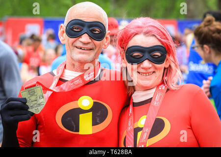London, UK. 28th Apil 2019. Two superhero runners at the finish line. Over 40,000 starters are once again competing in the Virgin London Marathon, including those who take on the race for charities, in running clubs, in memory of loved ones and as personal lifetime goals. Credit: Imageplotter/Alamy Live News Stock Photo