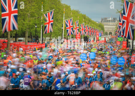 London, UK. 28th Apil 2019. Thousands of runners walk along the Mall, relieved to have crossed the finish line. (Long Exposure) Over 40,000 starters are once again competing in the Virgin London Marathon, including those who take on the race for charities, in running clubs, in memory of loved ones and as personal lifetime goals. Credit: Imageplotter/Alamy Live News Stock Photo