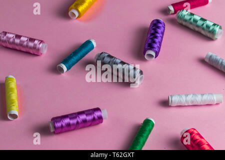 colorful sewing thread coils on the table. tailor's tool. top view photo. Stock Photo