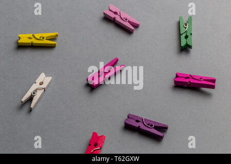 different clothes pegs lying on the gray table. design. Montessori's item. Stock Photo