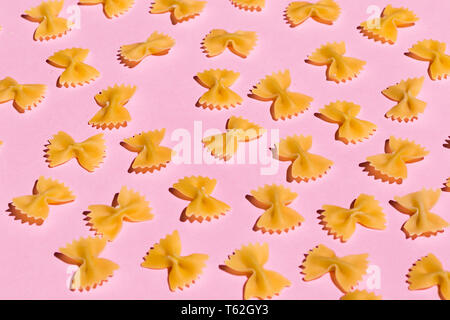 bow tie pasta isolated on pink background. top view Stock Photo