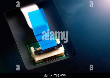 Computer connector and cable on the processor electronic board. Disassembly and cleaning of the computer. Part of laptop Stock Photo