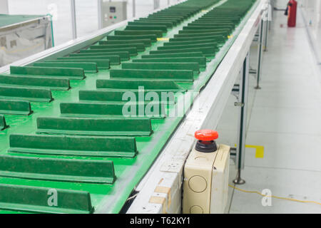 The emergency stop button on conveyor chain, and conveyor belt or auto machine  in production line area. Stock Photo