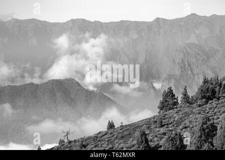 Black and white view from the Montana la Barquita over the Cumbre Vieja in La Palma, Spain to the distant Caldera de Taburiente. Stock Photo