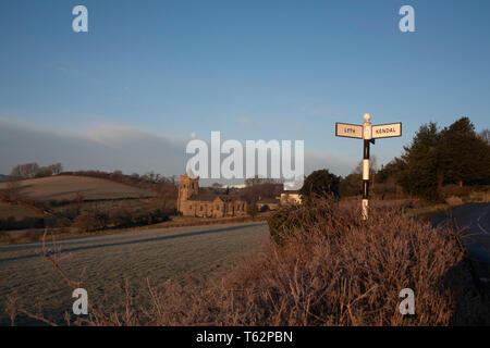 Crisp winter morning Church of St Mary's at Crosthwaite  road sign Lyth Valley between Kendal and Bowness On Windermere Lake District  Cumbria England Stock Photo