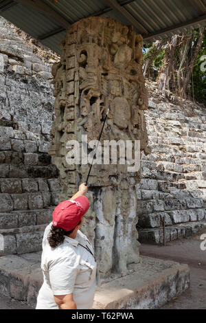 Tour Guide with Stele N, carved standing stone dating from AD 761; Maya ruins - Copan, Honduras Central America. Stock Photo