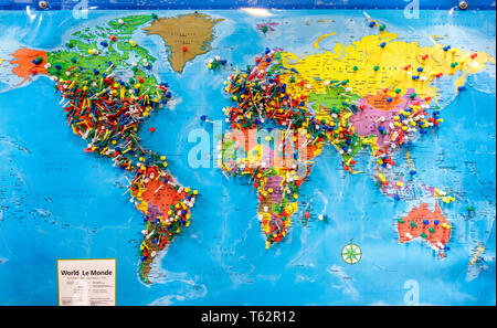 Push pins marking locations on a world map.