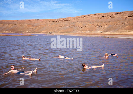 Tourists Floating On A Pool At The Salt Flats, Pedra Lume Salt Crater, Sal Island, Cape Verde, Africa Stock Photo