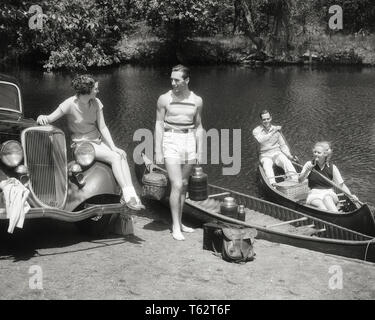1930s 1940s TWO COUPLES WITH PICNIC AND CAMPING GEAR LOADING TWO CANOES WOMAN SITTING ON FENDER OF CAR - c1890 HAR001 HARS COPY SPACE FRIENDSHIP HALF-LENGTH LADIES PERSONS AUTOMOBILE MALES TRANSPORTATION B&W SUMMERTIME LOADING HAPPINESS HIGH ANGLE CANOES ADVENTURE LEISURE AND AUTOS RECREATION THERMOS OARS AL FRESCO AUTOMOBILES PICNICKING STYLISH VEHICLES COOPERATION FENDER MID-ADULT MID-ADULT MAN MID-ADULT WOMAN TOGETHERNESS BLACK AND WHITE CAUCASIAN ETHNICITY HAR001 OLD FASHIONED Stock Photo